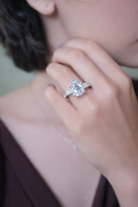 Château de Grâce — Pear-Cut Three-Stone Prestige Setting